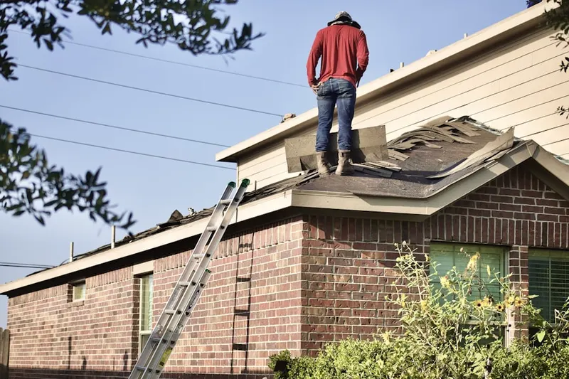 Professional roofer working on a residential roof in Georgica
